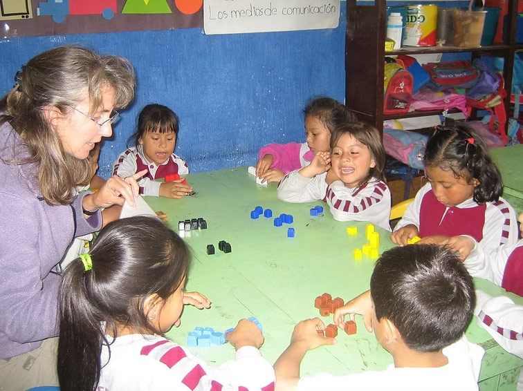 instructor works in the classroom with a group of students