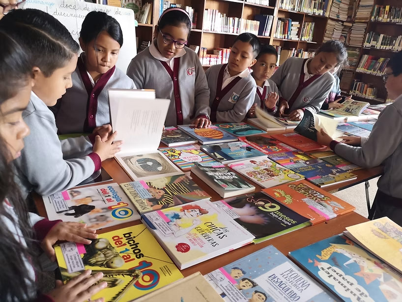 students look at a display of library books