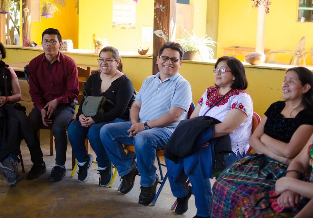 the academy director meets with a group of parents