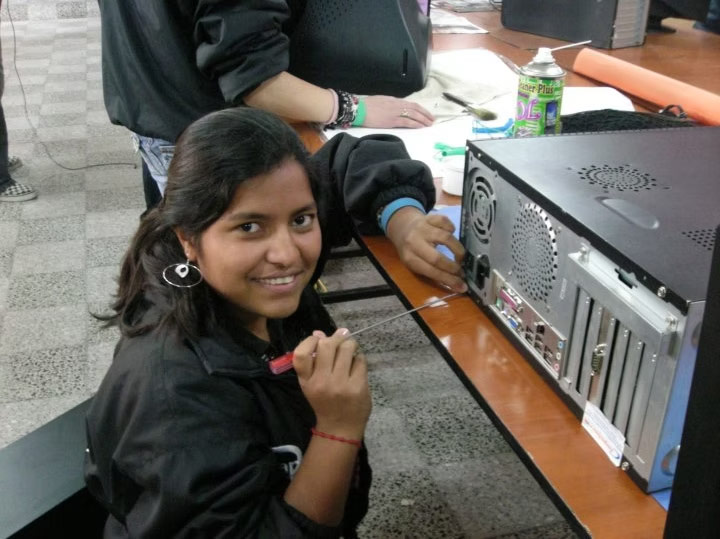 a young student performs repairs on an electronic device